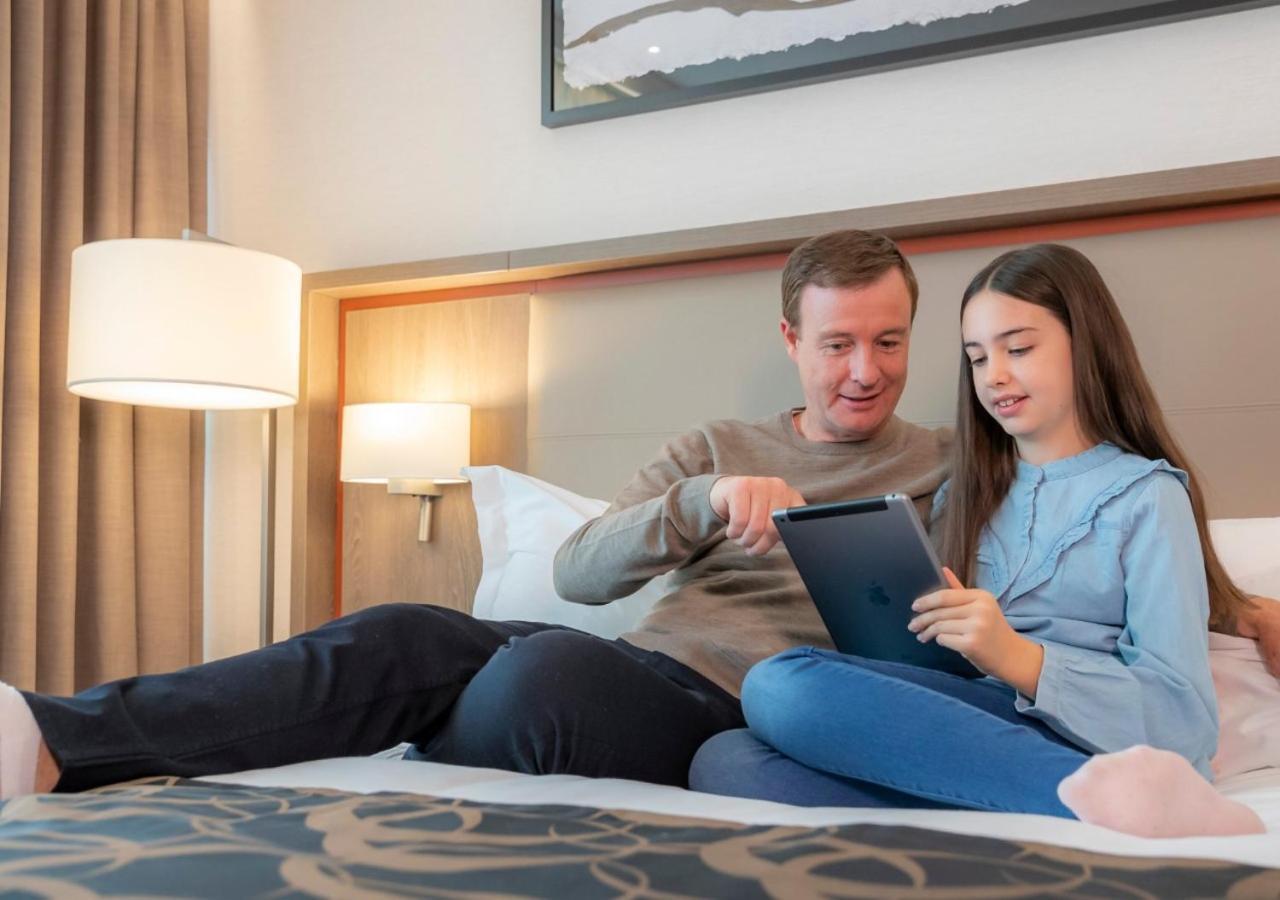Coolock Clayton Hotel Dublin Airport מראה חיצוני תמונה A father and daughter playing with a tablet