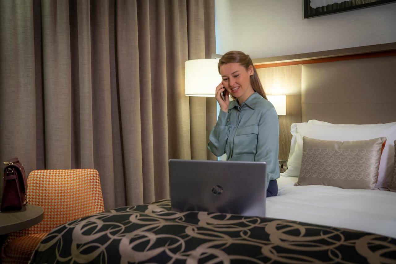 Coolock Clayton Hotel Dublin Airport מראה חיצוני תמונה A woman working from home.